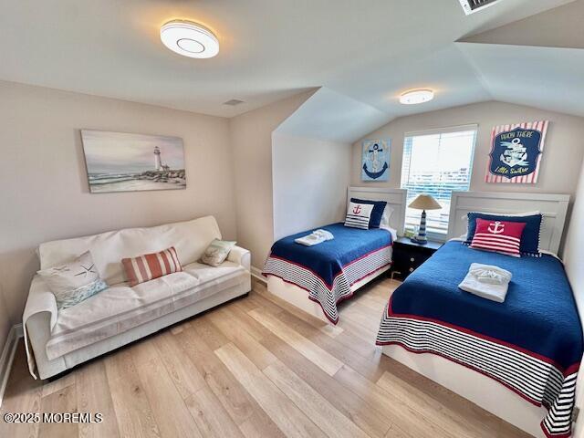 64 Sheridan Ave Unit A, Seaside Heights, NJ 08751 - bedroom featuring wood finished floors and vaulted ceiling