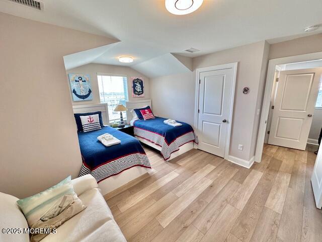 64 Sheridan Ave Unit A, Seaside Heights, NJ 08751 - bedroom featuring light wood-style floors, baseboards, and lofted ceiling