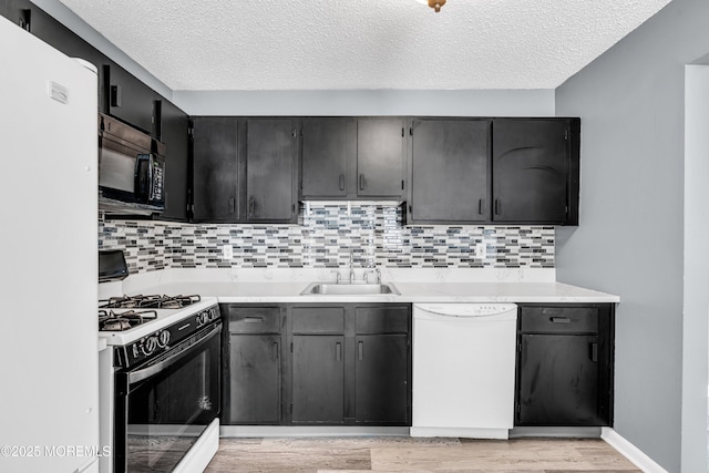 113 Whispering Oaks Way, Jackson, NJ 08527 - kitchen featuring white appliances, a sink, light wood-type flooring, a textured ceiling, and backsplash
