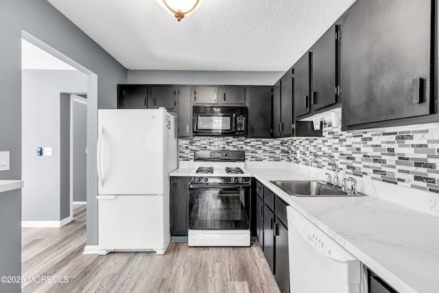 113 Whispering Oaks Way, Jackson, NJ 08527 - kitchen featuring white appliances, a sink, light wood-style floors, dark cabinetry, and a textured ceiling