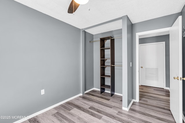 113 Whispering Oaks Way, Jackson, NJ 08527 - unfurnished bedroom with wood finished floors, a closet, baseboards, and ceiling fan