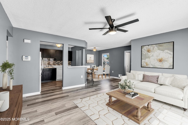 113 Whispering Oaks Way, Jackson, NJ 08527 - living room with wood finished floors, a ceiling fan, a textured ceiling, and baseboards