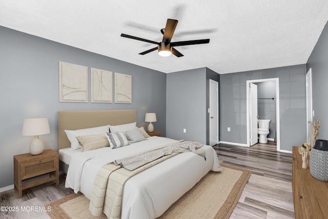 113 Whispering Oaks Way, Jackson, NJ 08527 - bedroom featuring wood finished floors, a textured ceiling, baseboards, ensuite bath, and a ceiling fan