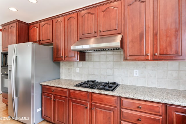 27 Witherspoon Way, Marlboro, NJ 07746 - kitchen with under cabinet range hood, black appliances, light stone counters, decorative backsplash, and recessed lighting
