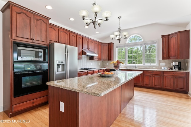 27 Witherspoon Way, Marlboro, NJ 07746 - kitchen featuring black appliances, a chandelier, lofted ceiling, under cabinet range hood, and a sink