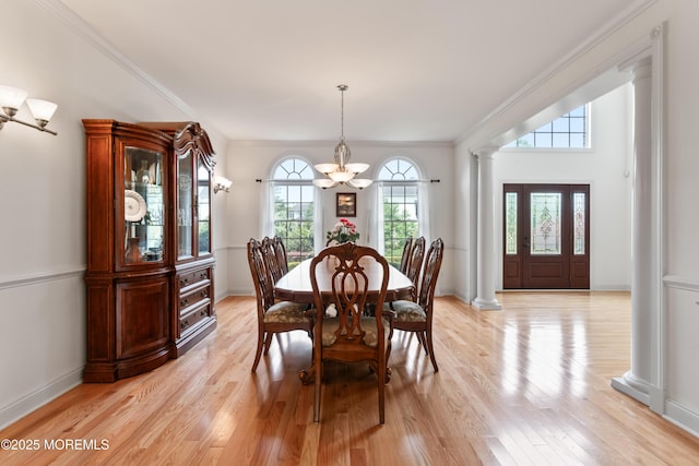 27 Witherspoon Way, Marlboro, NJ 07746 - dining space featuring decorative columns, a chandelier, light wood finished floors, crown molding, and baseboards
