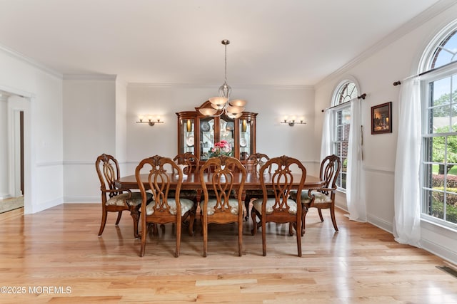 27 Witherspoon Way, Marlboro, NJ 07746 - dining area featuring light wood-style floors, a chandelier, plenty of natural light, ornamental molding, and baseboards