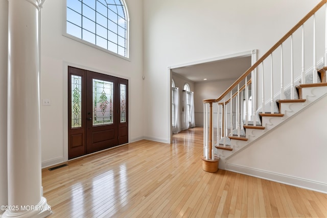 27 Witherspoon Way, Marlboro, NJ 07746 - foyer entrance with hardwood / wood-style floors, a towering ceiling, stairway, and baseboards
