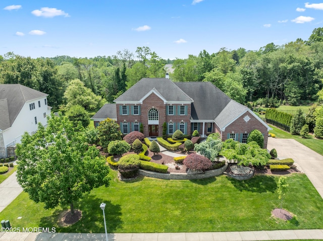 27 Witherspoon Way, Marlboro, NJ 07746 - colonial house featuring brick siding, a front lawn, and a shingled roof