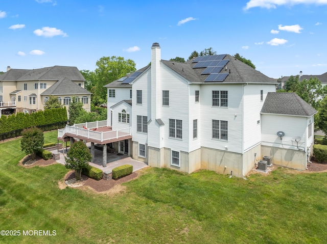 27 Witherspoon Way, Marlboro, NJ 07746 - rear view of property featuring a patio area, central AC unit, a chimney, a lawn, and a wooden deck