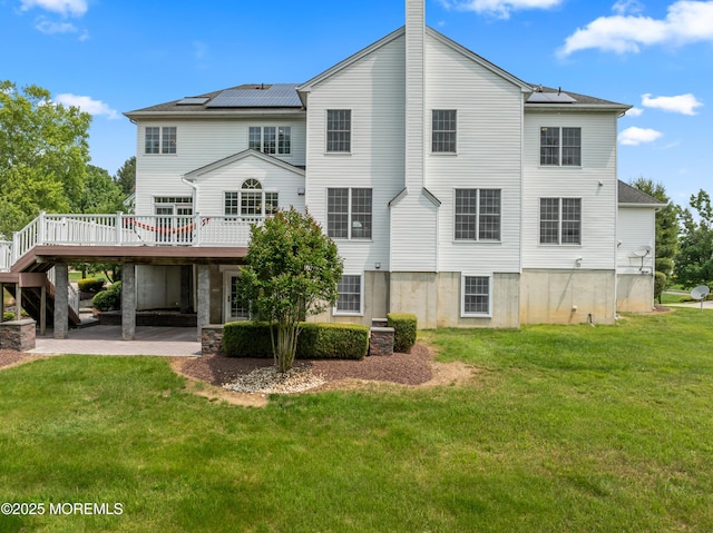 27 Witherspoon Way, Marlboro, NJ 07746 - back of property featuring a carport, a yard, a deck, solar panels, and a patio area