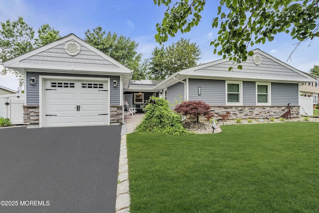 103 Idlewild Ln, Aberdeen, NJ 07747 - single story home with stone siding, roof mounted solar panels, a front yard, and driveway