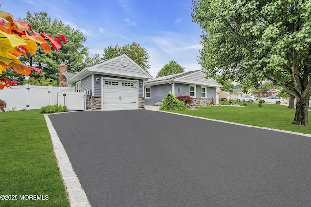 103 Idlewild Ln, Aberdeen, NJ 07747 - single story home with a gate, stone siding, asphalt driveway, and a garage