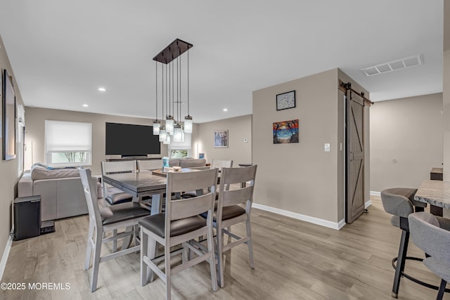 103 Idlewild Ln, Aberdeen, NJ 07747 - dining area featuring a barn door, light wood-style floors, baseboards, and recessed lighting
