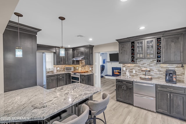 103 Idlewild Ln, Aberdeen, NJ 07747 - kitchen with a kitchen breakfast bar, light wood-style flooring, decorative backsplash, stainless steel appliances, and a sink
