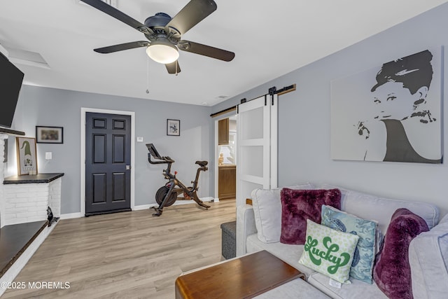 103 Idlewild Ln, Aberdeen, NJ 07747 - living area with a barn door, light wood-type flooring, a ceiling fan, and baseboards