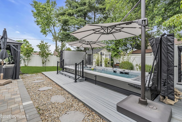 103 Idlewild Ln, Aberdeen, NJ 07747 - deck with an outdoor hot tub, a fenced backyard, and an outbuilding