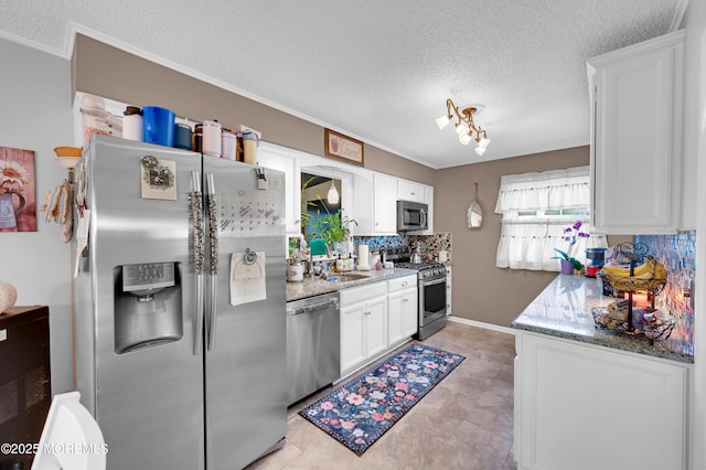 17 Evergreen Pl, Howell, NJ 07731 - kitchen featuring appliances with stainless steel finishes, decorative backsplash, a textured ceiling, white cabinetry, and light stone counters