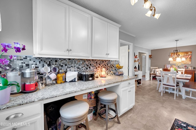 17 Evergreen Pl, Howell, NJ 07731 - kitchen with a chandelier, white cabinetry, decorative backsplash, pendant lighting, and a textured ceiling