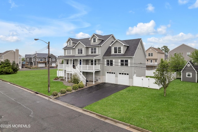728 Brook Ave, Union Beach, NJ 07735 - view of front of home with a residential view, a garage, asphalt driveway, and a porch