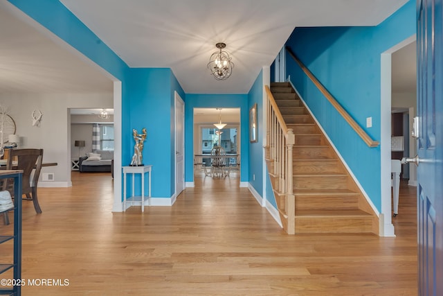 728 Brook Ave, Union Beach, NJ 07735 - entryway with stairs, a chandelier, light wood finished floors, and baseboards