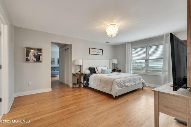 728 Brook Ave, Union Beach, NJ 07735 - bedroom with light wood-style flooring, baseboards, and a chandelier