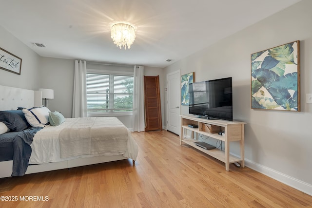 728 Brook Ave, Union Beach, NJ 07735 - bedroom featuring a chandelier, light wood-style flooring, and baseboards