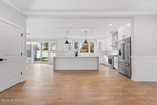 1119 Northstream Pkwy, Point Pleasant, NJ 08742 - kitchen featuring premium appliances, wall chimney exhaust hood, white cabinets, light wood finished floors, and crown molding