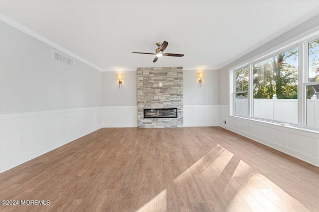 1119 Northstream Pkwy, Point Pleasant, NJ 08742 - unfurnished living room featuring a ceiling fan, ornamental molding, wood finished floors, a fireplace, and wainscoting