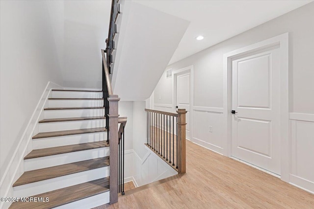 1119 Northstream Pkwy, Point Pleasant, NJ 08742 - stairs with a decorative wall, wood finished floors, recessed lighting, and wainscoting