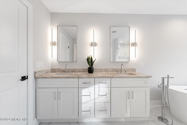 1119 Northstream Pkwy, Point Pleasant, NJ 08742 - full bath with double vanity, a freestanding bath, marble look tiles, and baseboards