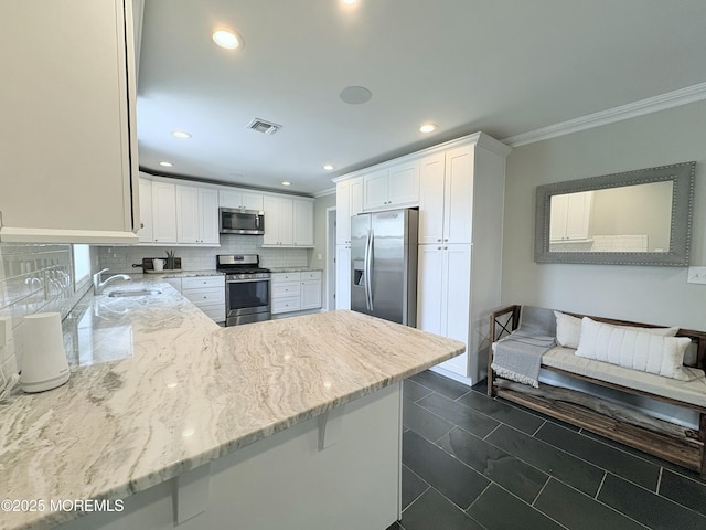 23 Brainard Ave, Port Monmouth, NJ 07758 - kitchen featuring appliances with stainless steel finishes, crown molding, light stone counters, white cabinetry, and backsplash