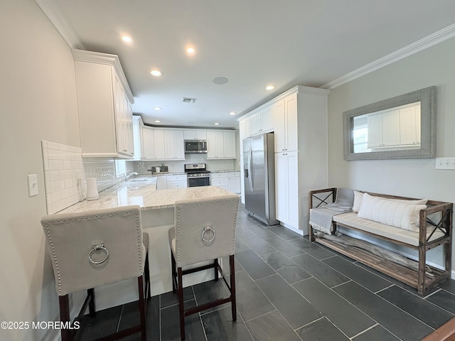 23 Brainard Ave, Port Monmouth, NJ 07758 - kitchen with stainless steel appliances, a peninsula, tasteful backsplash, light stone countertops, and white cabinetry