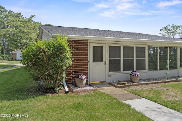 1036A Aberdeen Dr, Lakewood, NJ 08701 - view of front facade with a shingled roof, a front yard, and brick siding