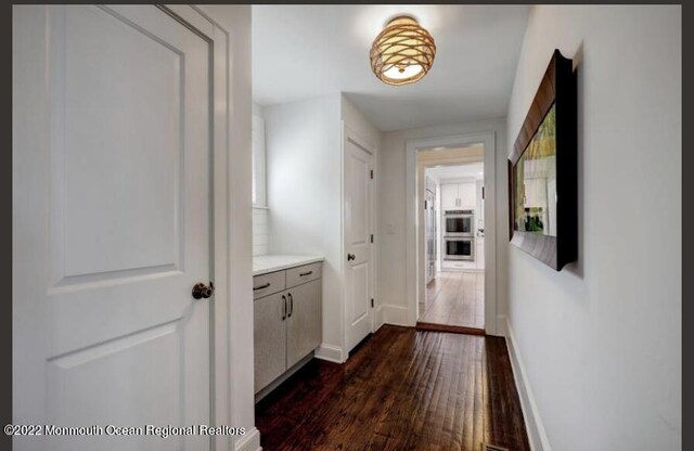 1 S Ocean Ave, Loch Arbour, NJ 07711 - hall with dark wood-type flooring and baseboards