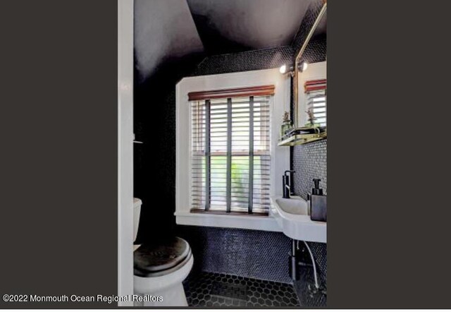 1 S Ocean Ave, Loch Arbour, NJ 07711 - bathroom featuring toilet, healthy amount of natural light, tile patterned flooring, and lofted ceiling