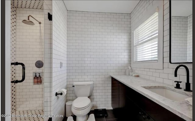 1 S Ocean Ave, Loch Arbour, NJ 07711 - bathroom featuring tile walls, vanity, a shower stall, toilet, and backsplash