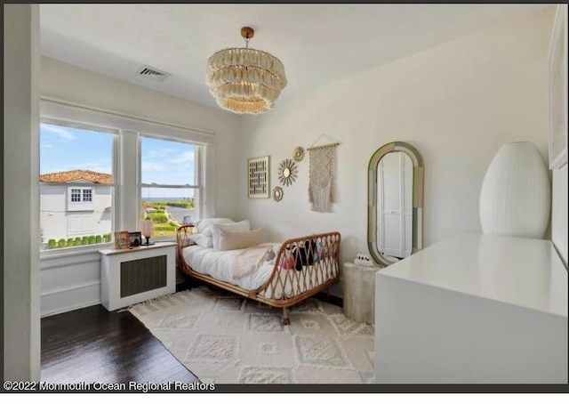 1 S Ocean Ave, Loch Arbour, NJ 07711 - bedroom with radiator heating unit, a chandelier, and light wood finished floors