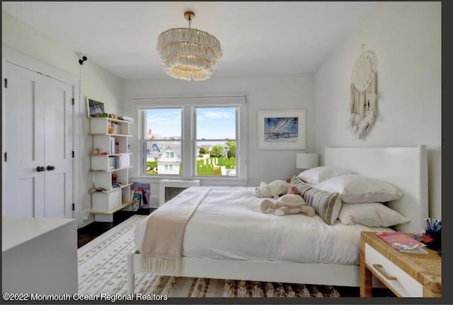 1 S Ocean Ave, Loch Arbour, NJ 07711 - bedroom featuring a chandelier, wood finished floors, and radiator heating unit