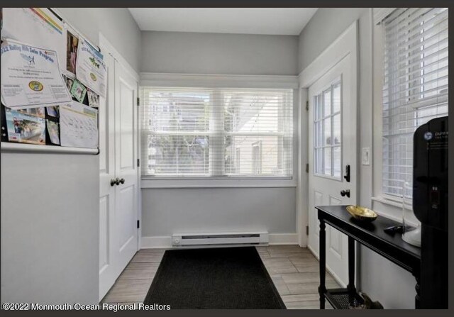 1 S Ocean Ave, Loch Arbour, NJ 07711 - entryway with a baseboard radiator, light wood-type flooring, and baseboards