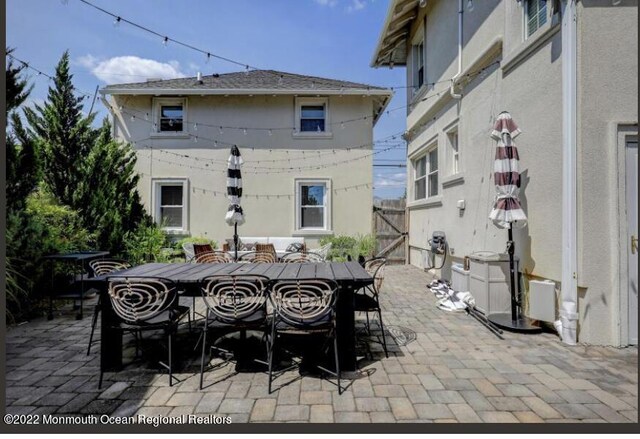 1 S Ocean Ave, Loch Arbour, NJ 07711 - view of patio featuring outdoor dining area and a gate