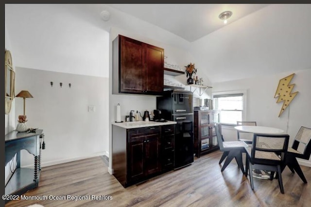 1 S Ocean Ave, Loch Arbour, NJ 07711 - kitchen featuring lofted ceiling, freestanding refrigerator, light wood-style floors, light countertops, and open shelves