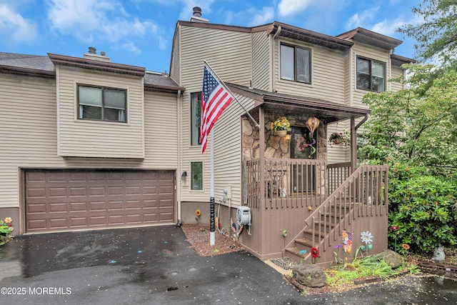 11 Kennedy Ct, Middletown, NJ 07748 - view of property featuring an attached garage, driveway, covered porch, and a chimney