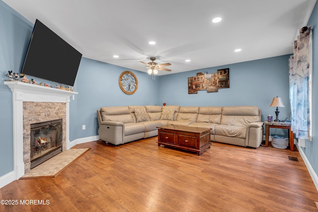 11 Kennedy Ct, Middletown, NJ 07748 - living area featuring ceiling fan, recessed lighting, light wood finished floors, a stone fireplace, and baseboards