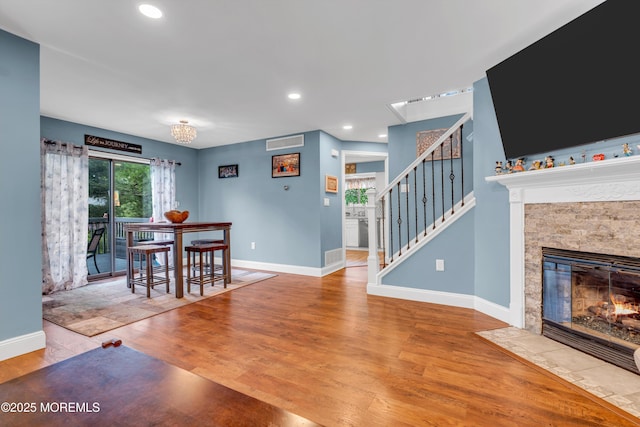 11 Kennedy Ct, Middletown, NJ 07748 - dining room with baseboards, wood finished floors, stairway, a fireplace with flush hearth, and recessed lighting
