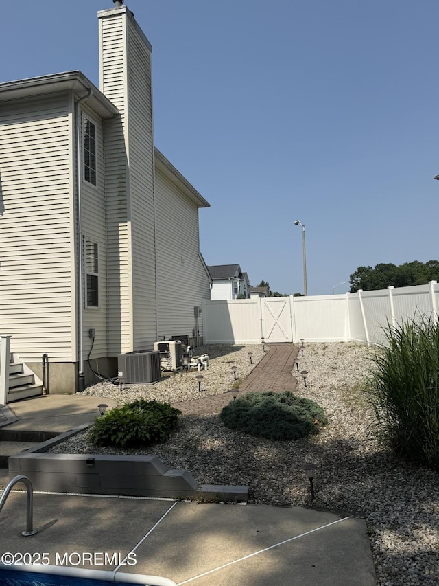 44 Diamond Ln, Howell, NJ 07731 - view of property exterior featuring a chimney and a patio area
