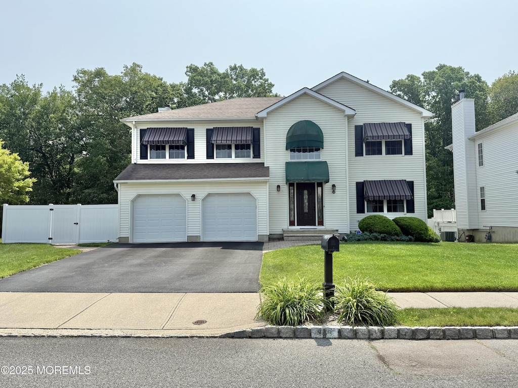 44 Diamond Ln, Howell, NJ 07731 - traditional-style house featuring a gate, driveway, and an attached garage