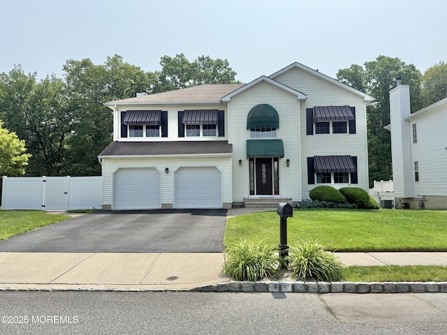44 Diamond Ln, Howell, NJ 07731 - traditional-style house featuring a gate, driveway, and an attached garage
