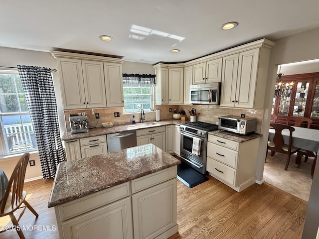 44 Diamond Ln, Howell, NJ 07731 - kitchen featuring stainless steel appliances, light wood-type flooring, a chandelier, dark stone counters, and recessed lighting