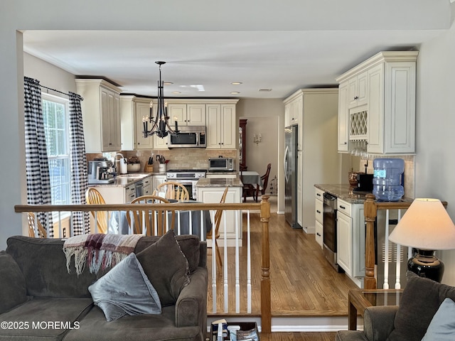 44 Diamond Ln, Howell, NJ 07731 - kitchen featuring stainless steel appliances, cream cabinets, open floor plan, a chandelier, and recessed lighting